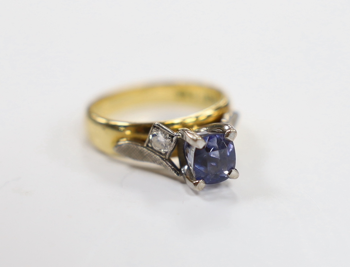 An 18ct and single stone oval cut sapphire set dress ring, with diamond set shoulders, size I, gross weight 5.6 grams.